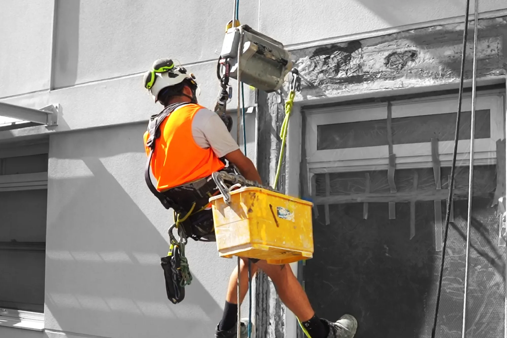 Rope access technician carrying out façade work at UNSW New College, NSW